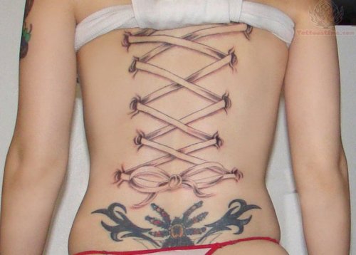 Croset And Tribal Lowerback Tattoo